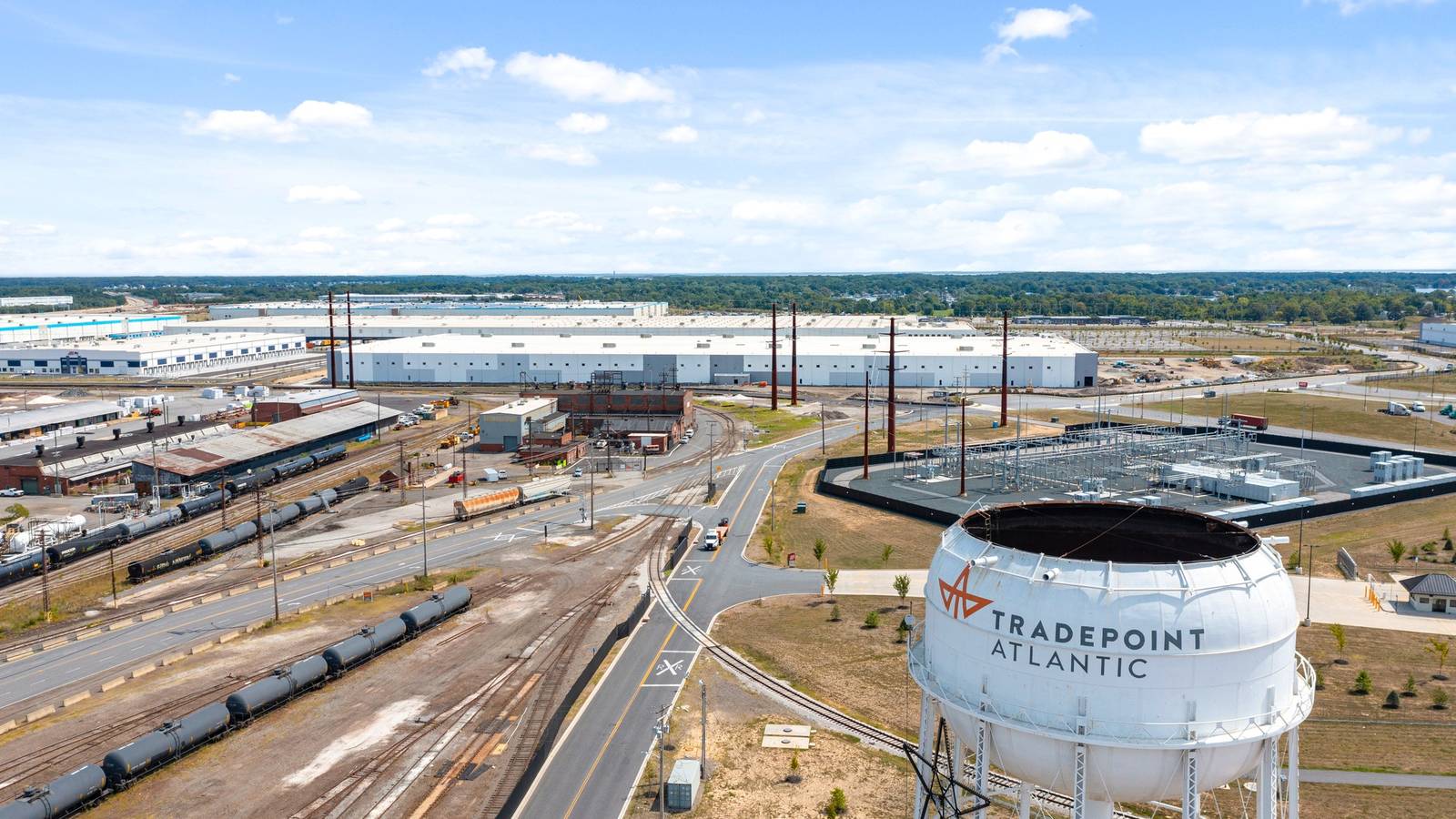 Aerial view of the Tradepoint Atlantic water tower, rail lines and large warehouses at Sparrows Point near Baltimore