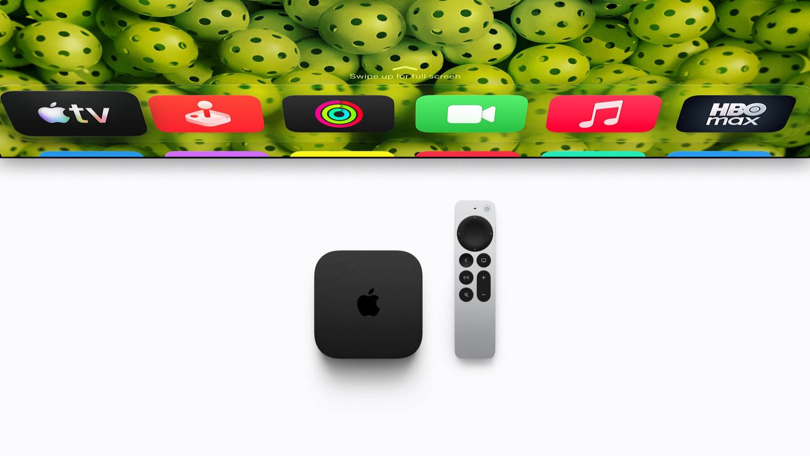 The new black Apple TV 4K box beside a silver Siri Remote, below a row of app icons on a TV screen