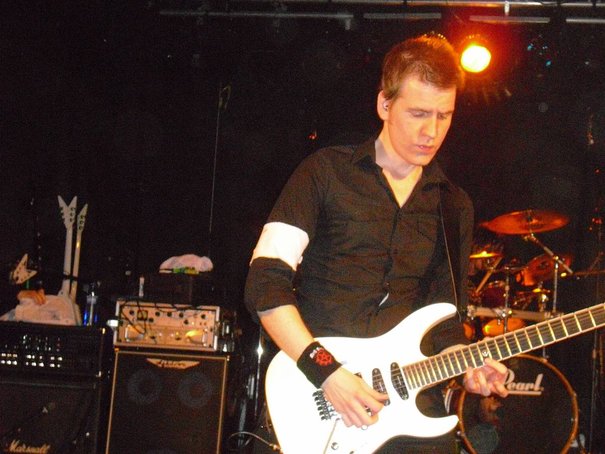 Arch Enemy guitarist Christopher Amott playing on a club stage