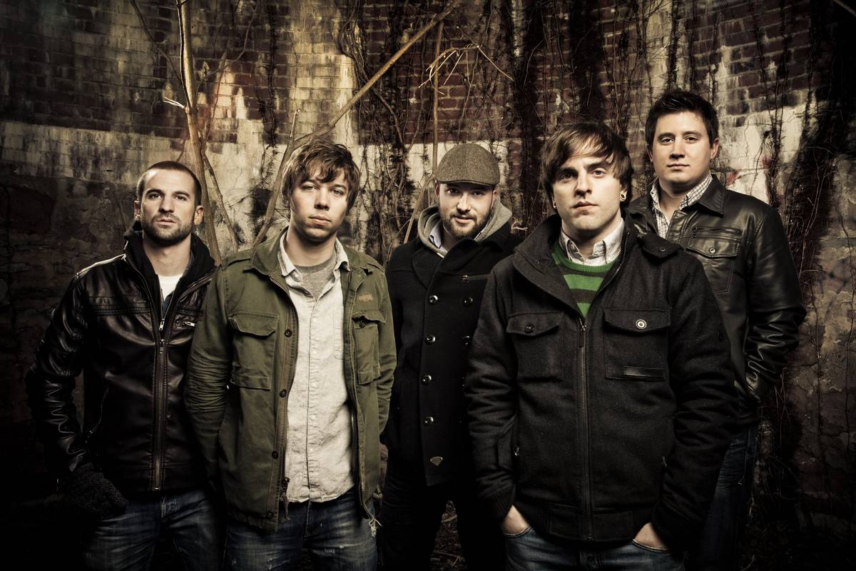 The five members of August Burns Red posing together in dark jackets