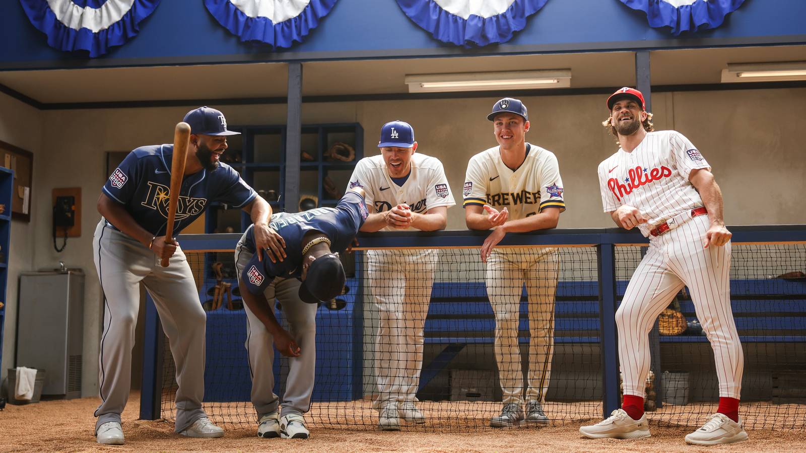 Bryce Harper, Freddie Freeman and other MLB stars laughing in a dugout set during the Avengers Doomsday shoot