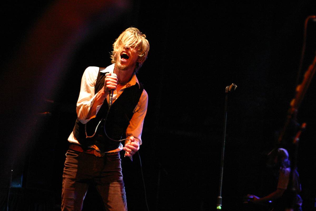 Blindside singer Christian Lindskog singing on a dark club stage