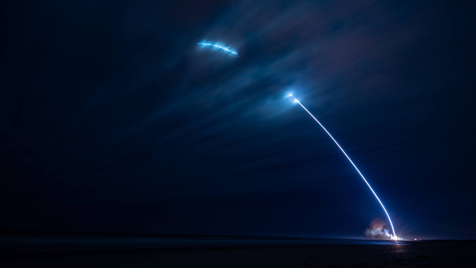 A long exposure trail of the first New Glenn launch arcing into the night sky over Cape Canaveral