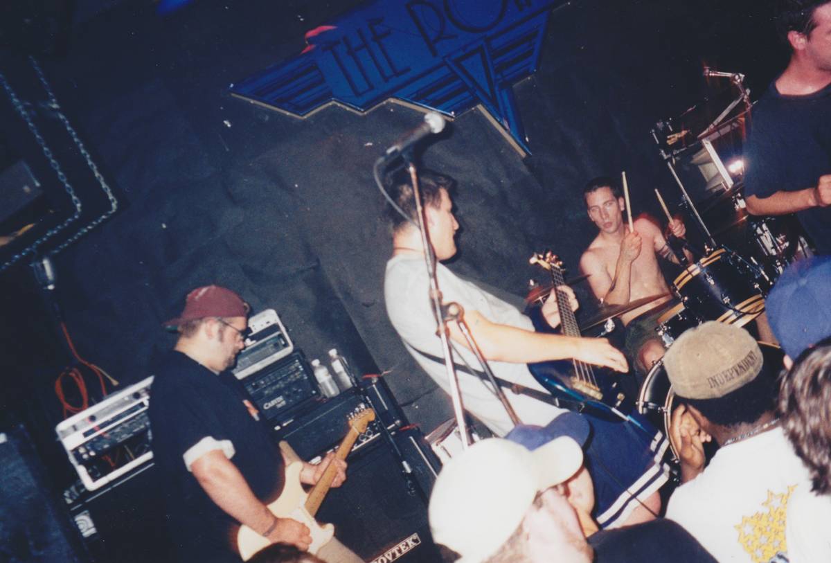 Boysetsfire playing a packed club with a fan near the stage