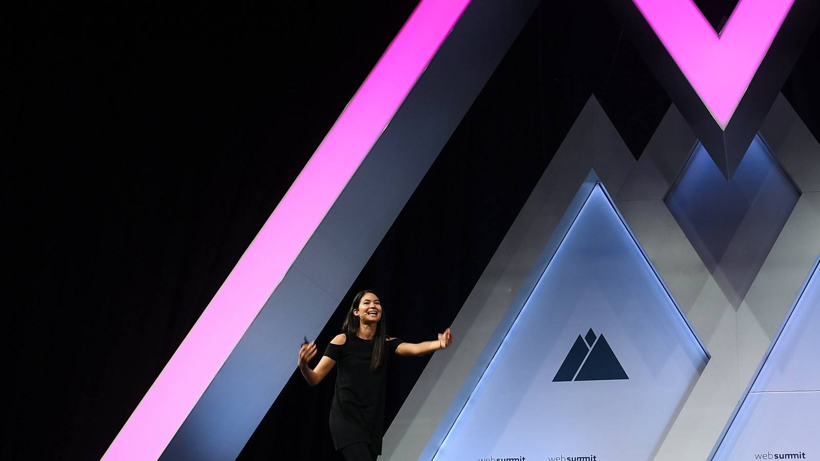 Canva cofounder and chief executive Melanie Perkins speaking alone on a lit stage at Web Summit in Lisbon