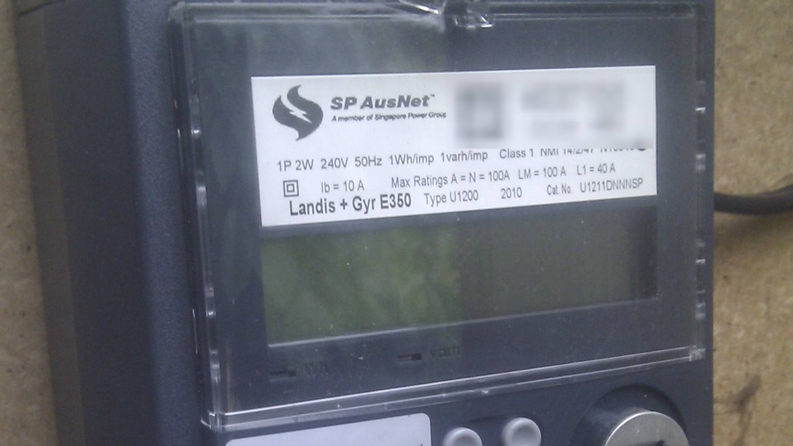 Close up of a grey Landis and Gyr electricity smart meter with its rating label and blank display panel