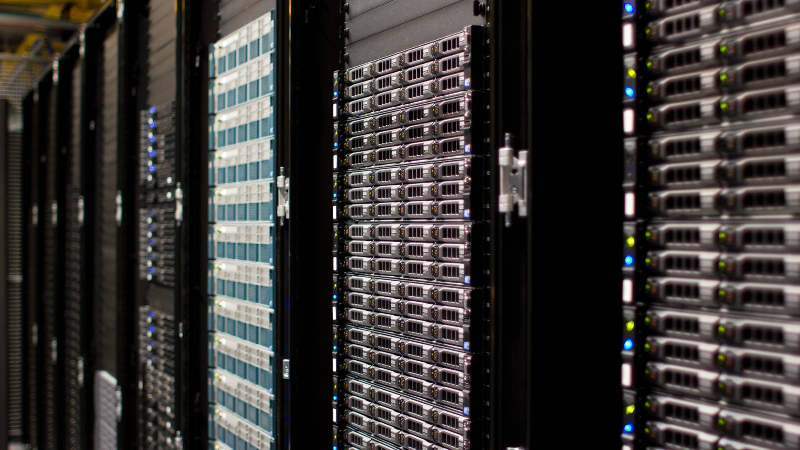 Rows of server racks with glowing status lights in a data centre