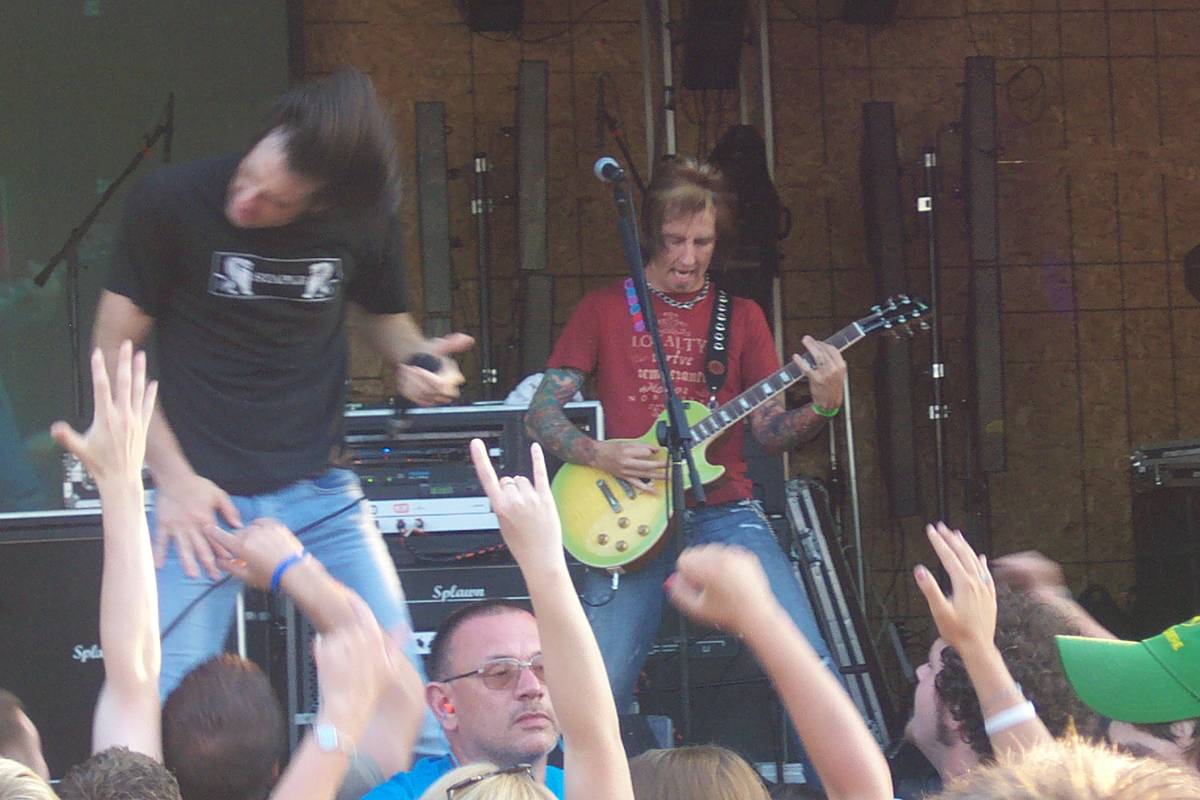 Disciple playing in front of a crowd with raised hands