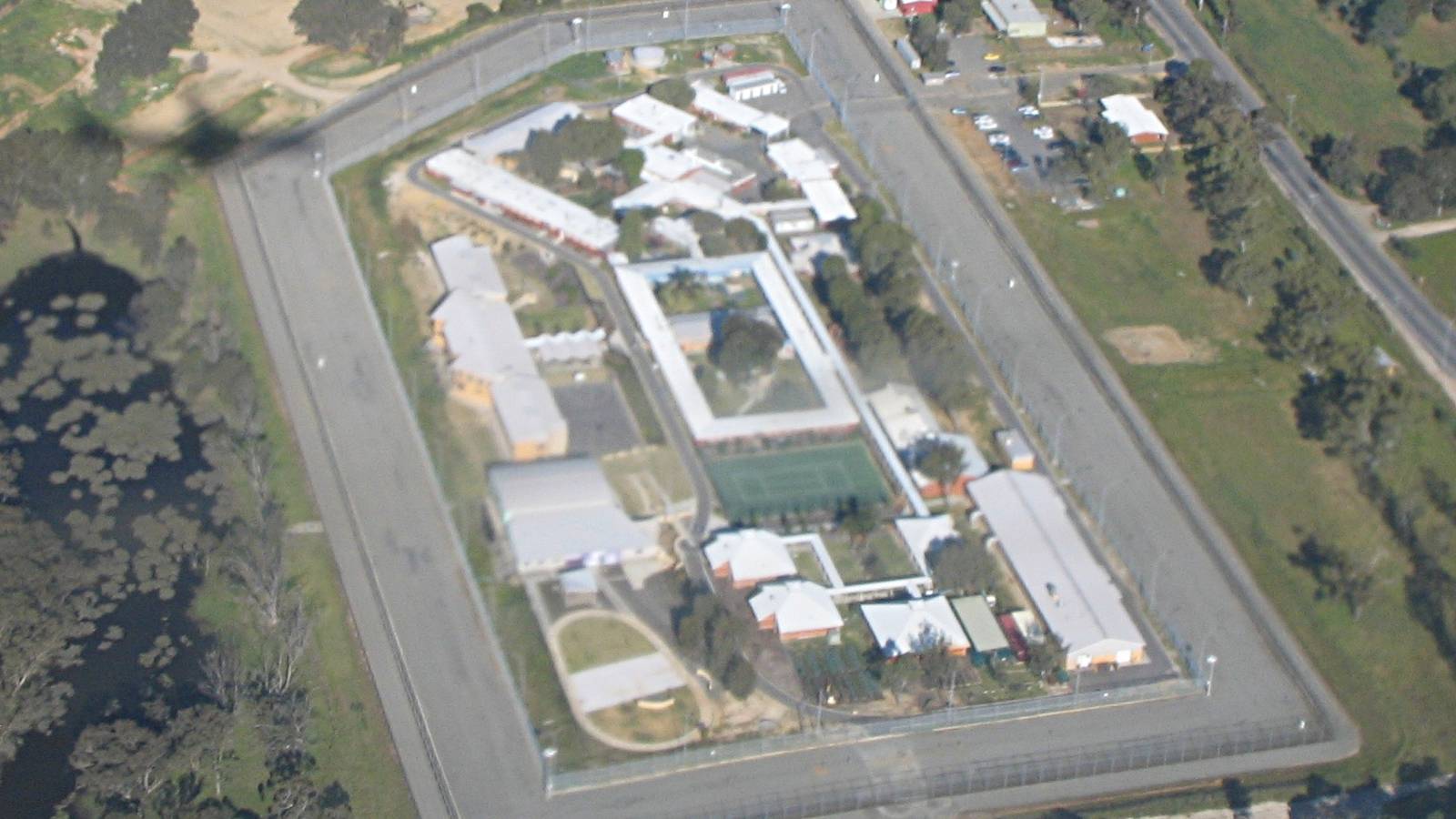 Aerial view of Bandyup Women's Prison in Perth with its perimeter fence, buildings and sports court