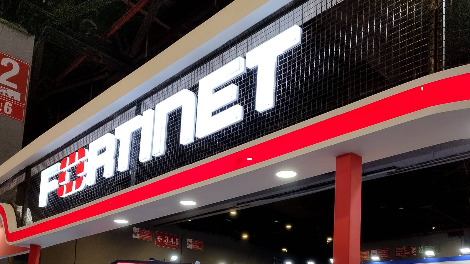 Large red and white Fortinet signs on the company's exhibition stand at a conference in Delhi