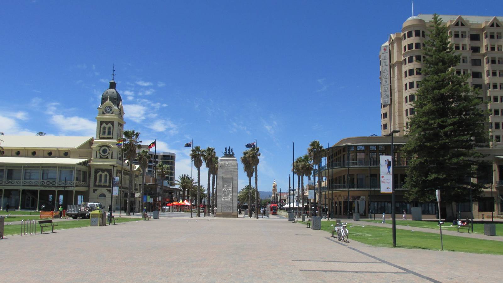 Moseley Square in Glenelg, Adelaide, with the town hall clock tower, palm trees and seaside buildings