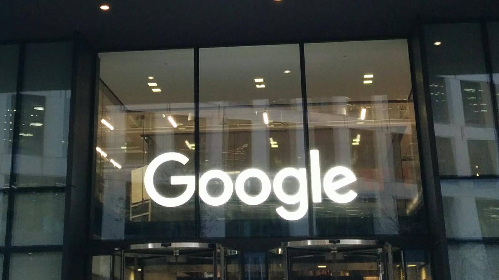 The lit Google sign over the entrance at 6 Pancras Square in London, home to Google DeepMind