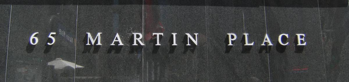 Close-up of the 65 Martin Place lettering on the Reserve Bank building’s dark stone wall, Sydney