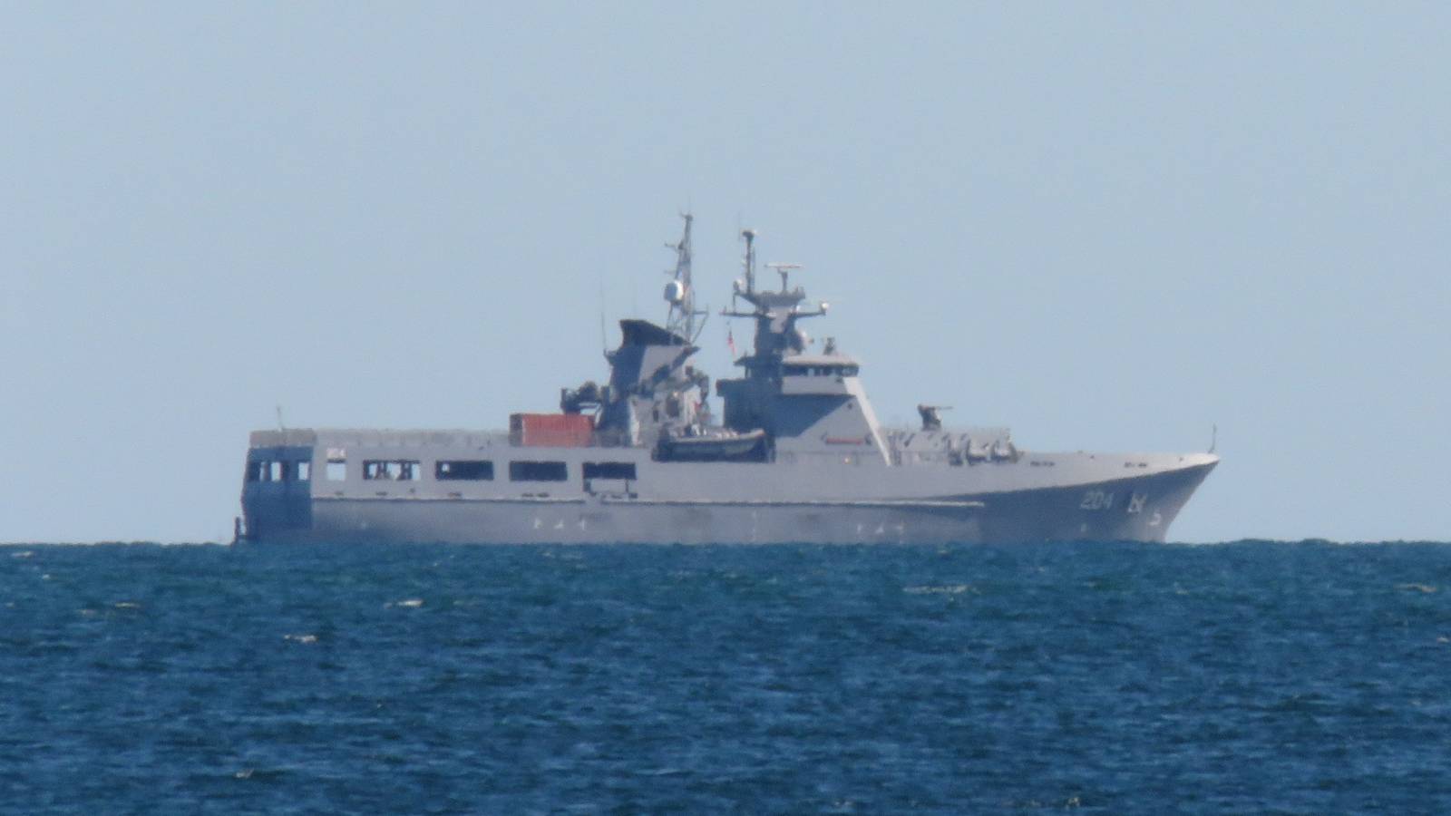 The grey patrol vessel HMAS Eyre under way on blue water in Cockburn Sound, Western Australia