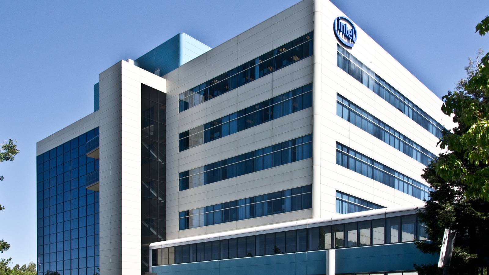 Intel's glass and white headquarters tower in Santa Clara, California, with the Intel logo near the roof