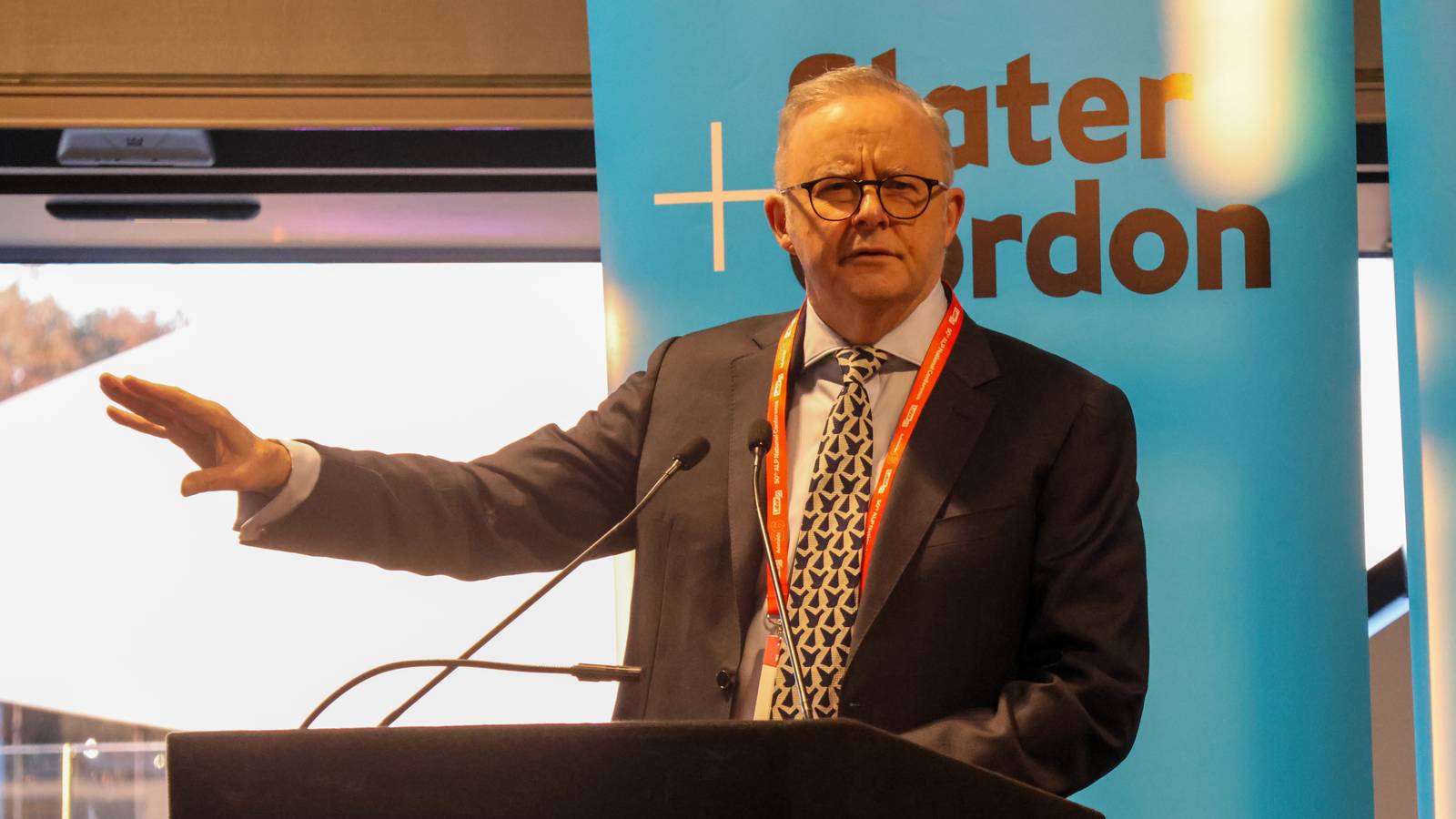 Anthony Albanese gestures while speaking at a lectern at the Australian Labor Party National Conference in Adelaide
