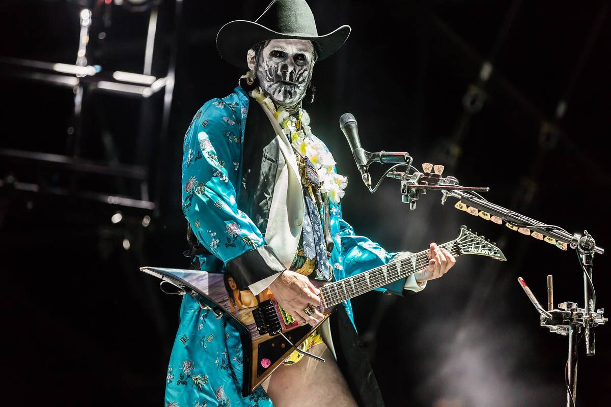 Limp Bizkit guitarist Wes Borland in costume playing on stage