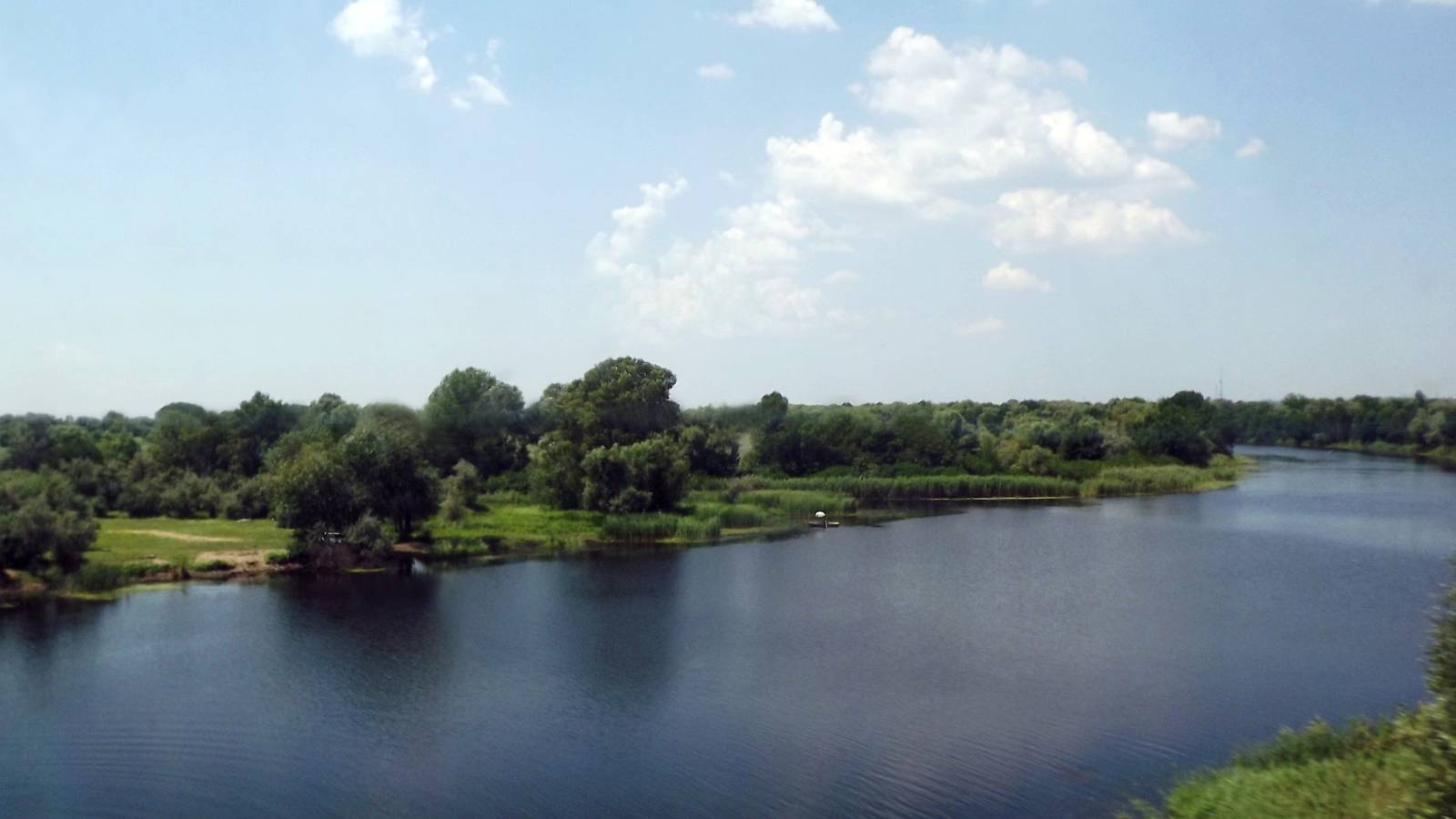 The Konka River winding past green riverbanks near Oleshky in Ukraine's Kherson region