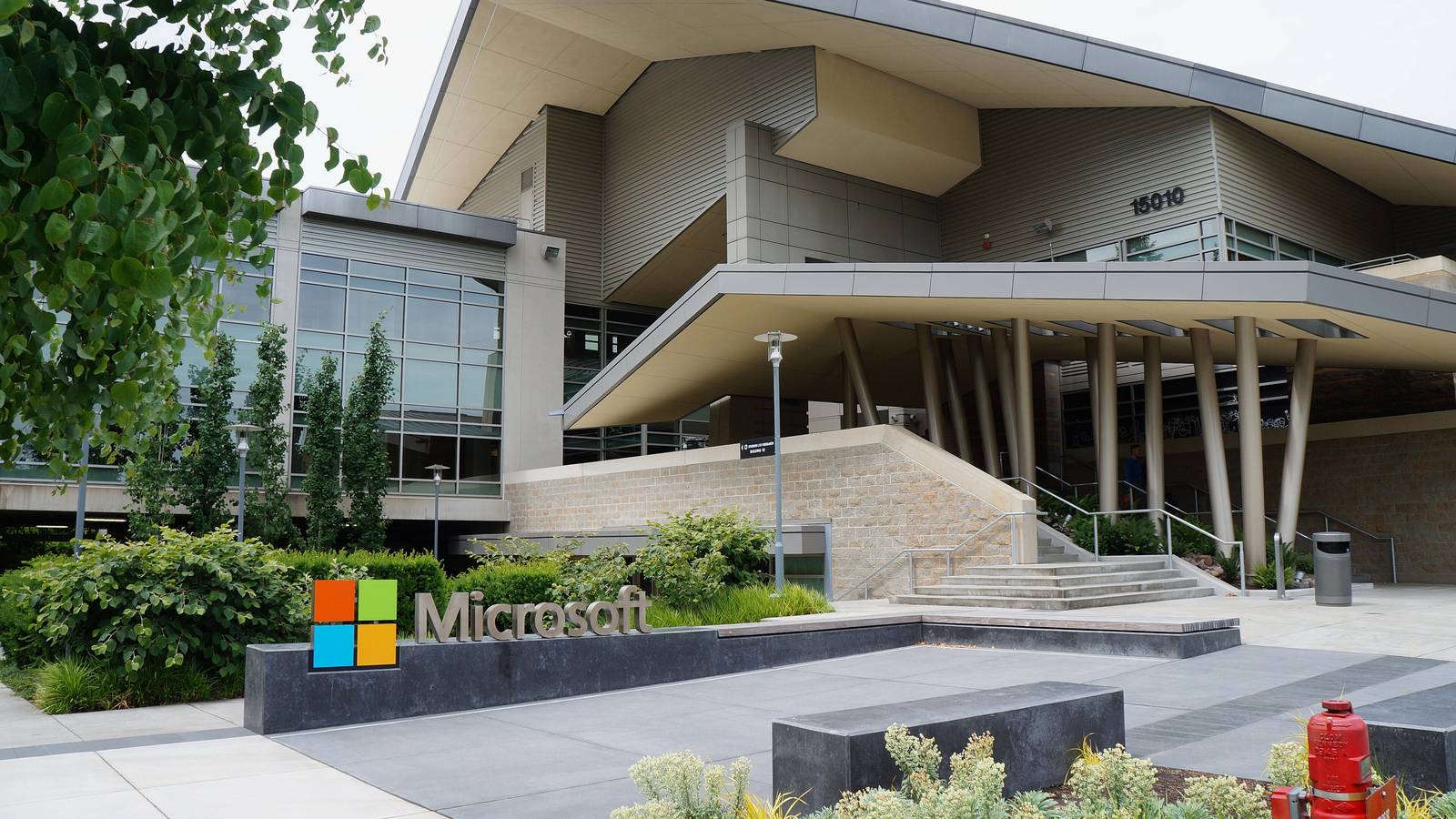 Microsoft logo sign outside Building 92, a modern glass and concrete building on the Redmond campus