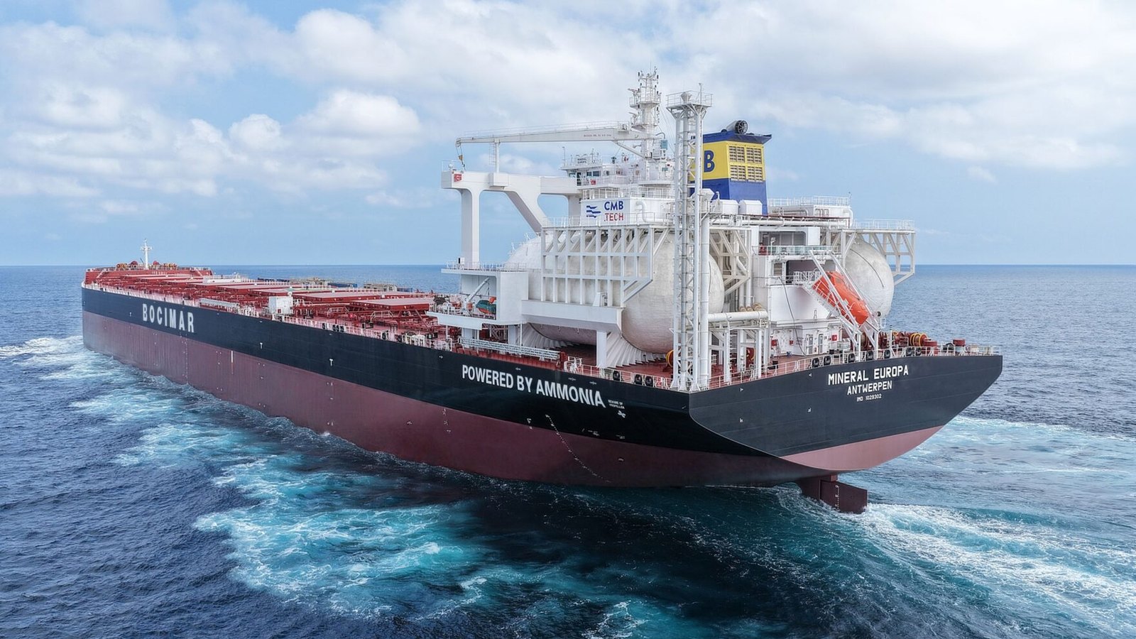 Mineral Europa at sea, its black hull marked Bocimar and Powered by Ammonia, with big white fuel tanks near the stern