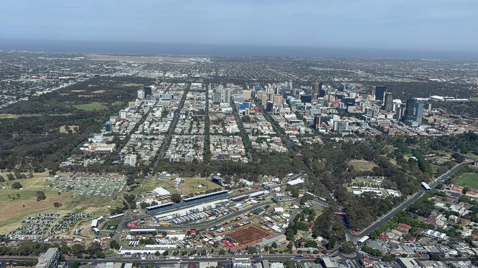 Aerial view of Victoria Park and tree lined eastern park lands in Adelaide with the street circuit pit buildings