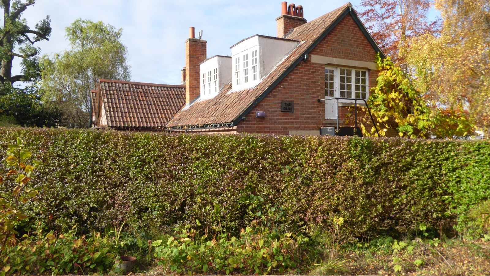 The Kilns, the Oxford home of C. S. Lewis, seen across a garden hedge