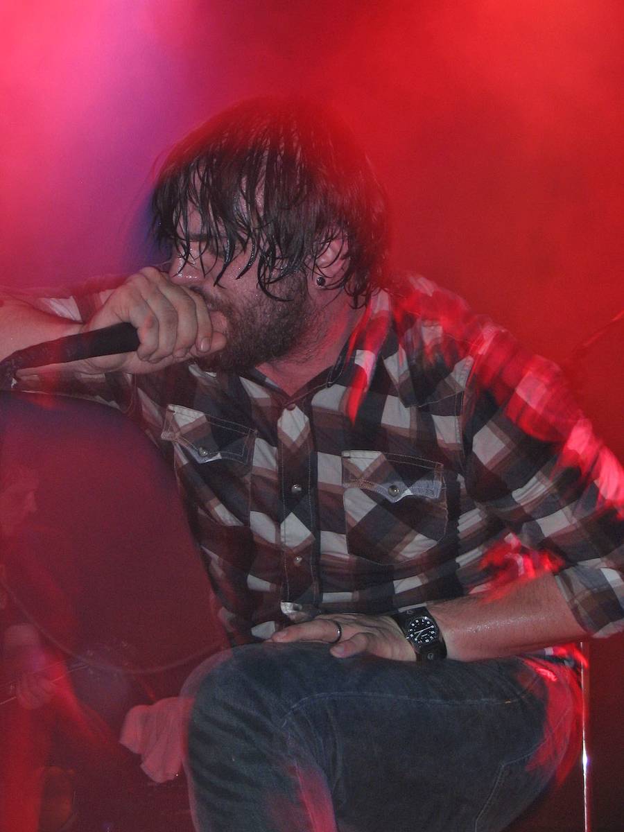 Norma Jean singer Cory Brandan Putman singing in a plaid shirt