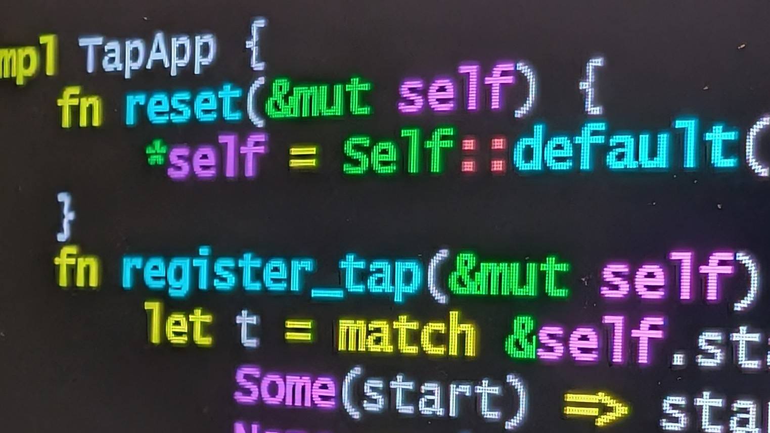 Close up of colourful Rust source code on a dark computer screen