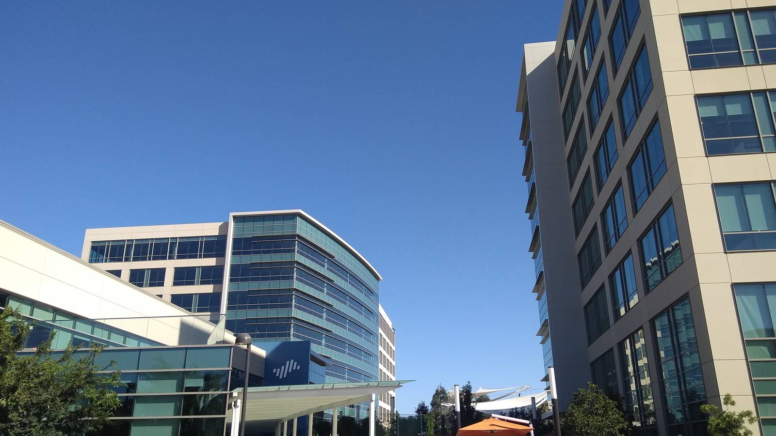 Glass office towers at the Palo Alto Networks headquarters in Santa Clara under a blue sky