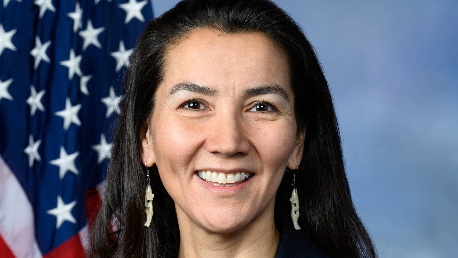Mary Peltola smiling in her official House portrait, with an American flag behind her