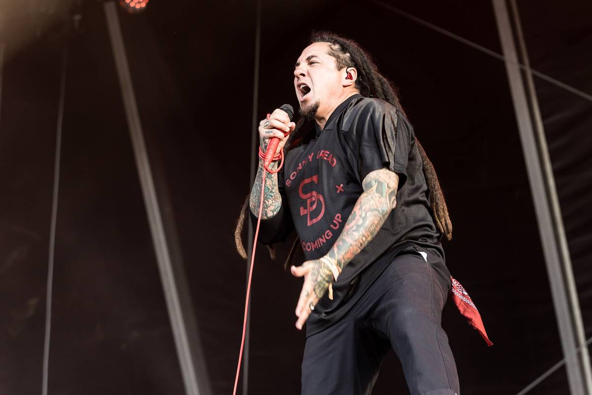P.O.D. singer Sonny Sandoval singing on a festival stage