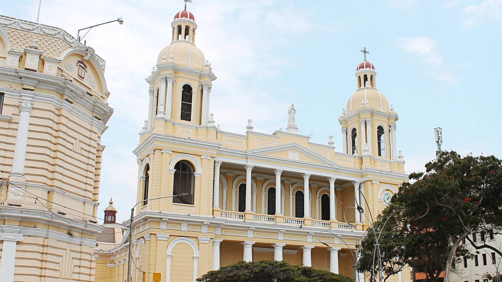 The cream and yellow twin towered Cathedral of Chiclayo in Peru under a pale blue sky
