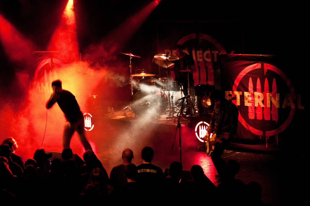 Project 86 singer Andrew Schwab silhouetted against red stage lights