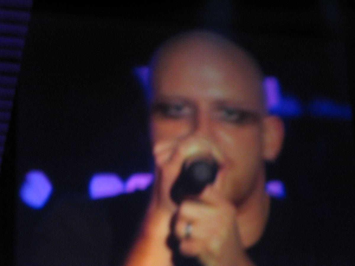 Blurred close up of Red singer Michael Barnes singing into a microphone