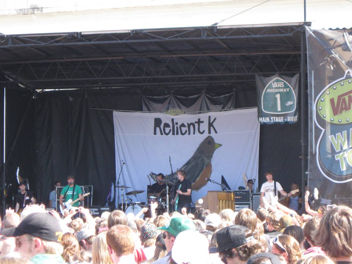 Relient K playing a Warped Tour stage in front of an outdoor crowd