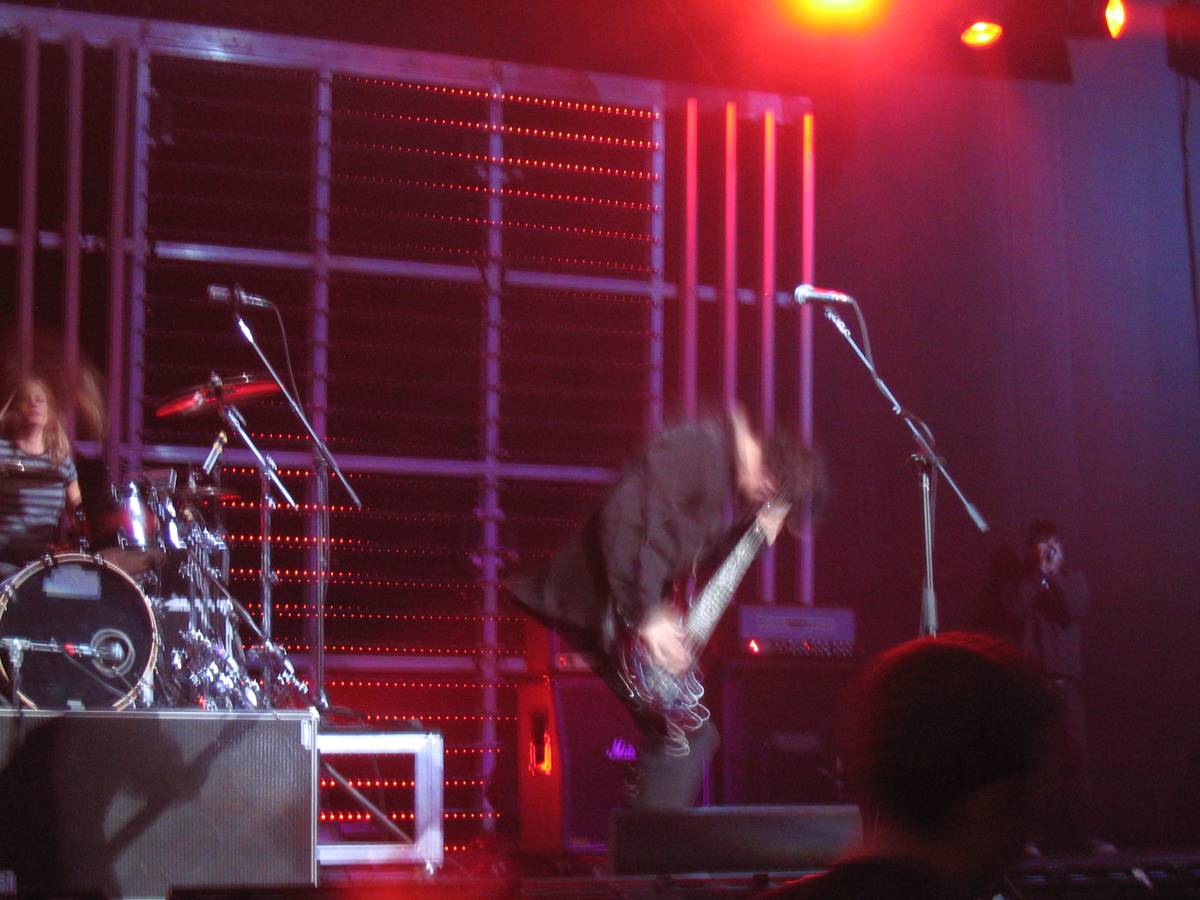 Skillet playing a stage lit in red and purple