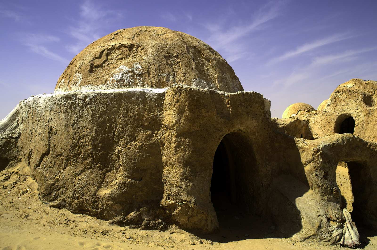 A domed sandstone hut on the abandoned Mos Espa film set from The Phantom Menace, in the desert near Nefta, Tunisia