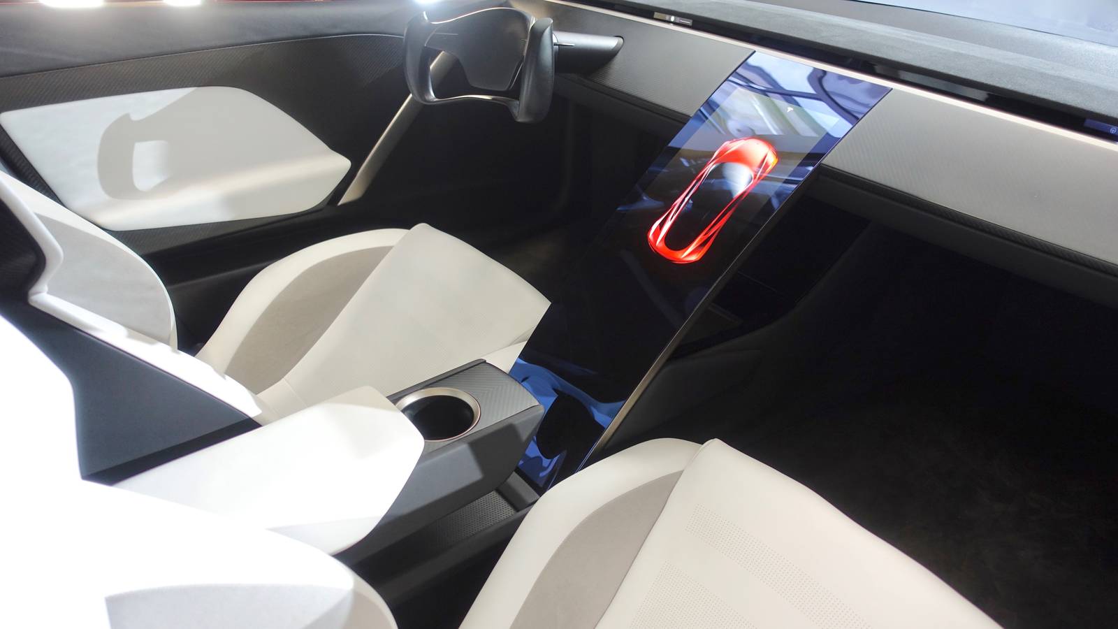 Interior of the second generation Tesla Roadster prototype with white seats and a central touchscreen