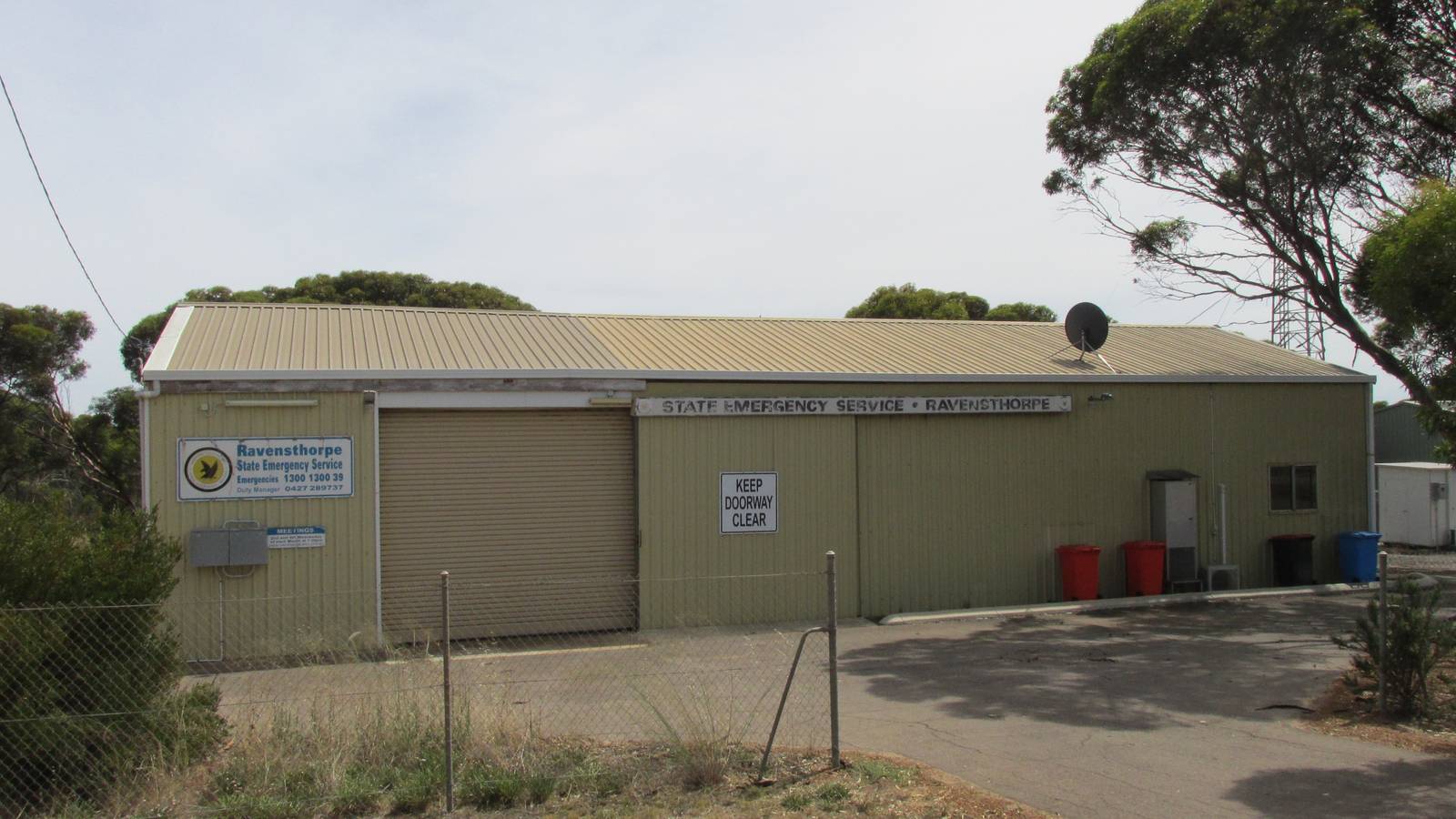 A pale green State Emergency Service shed with a roller door in Ravensthorpe, Western Australia