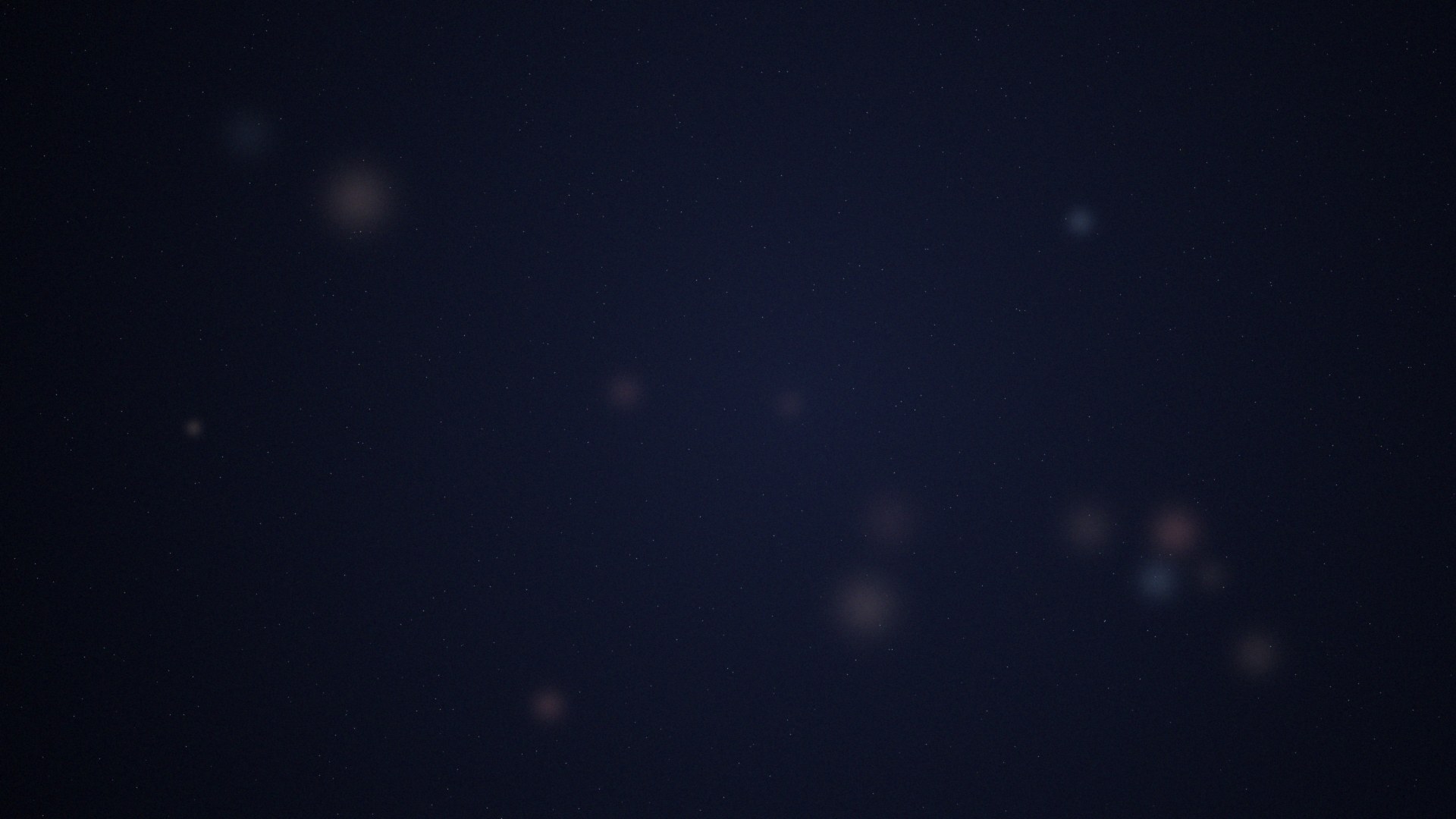 Abstract dark field of soft icy planetesimal glows and stars