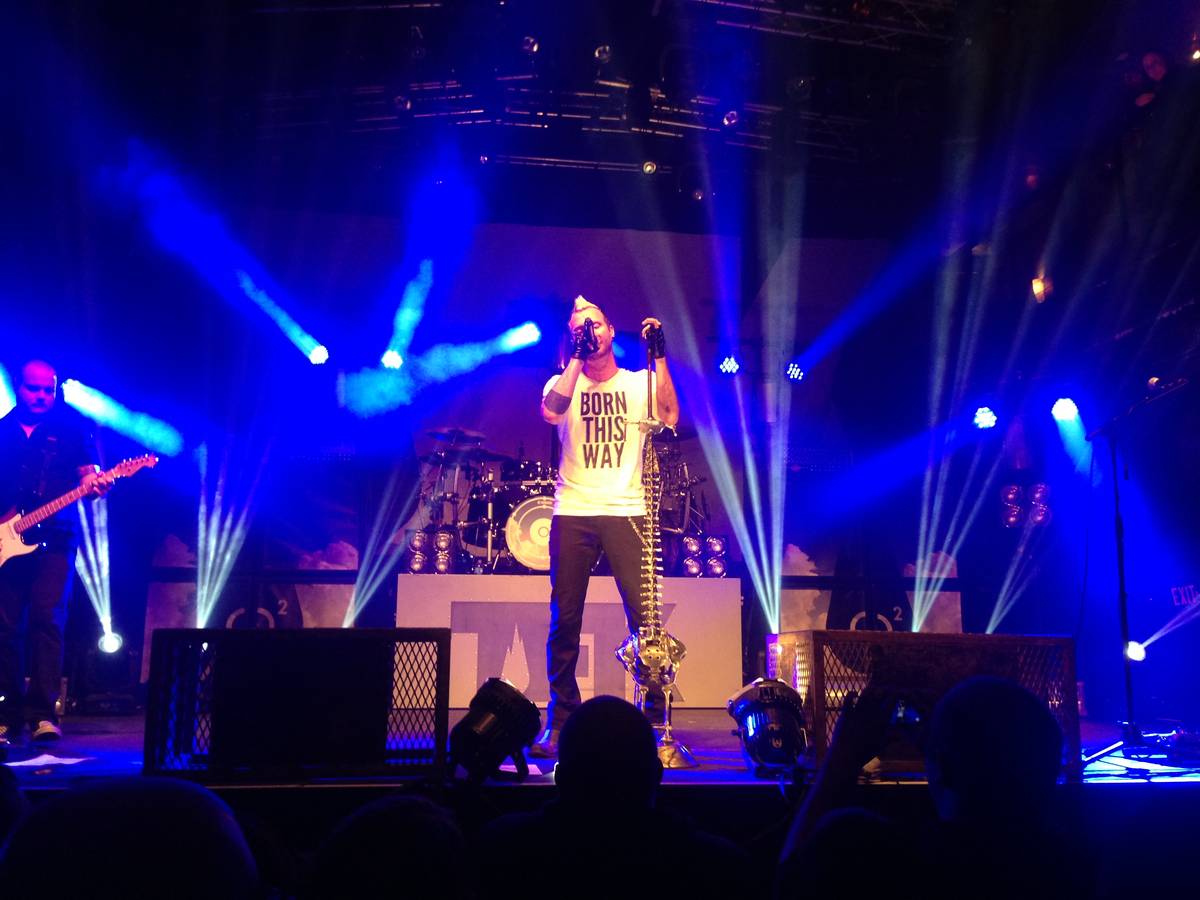 Thousand Foot Krutch on a club stage lit in blue
