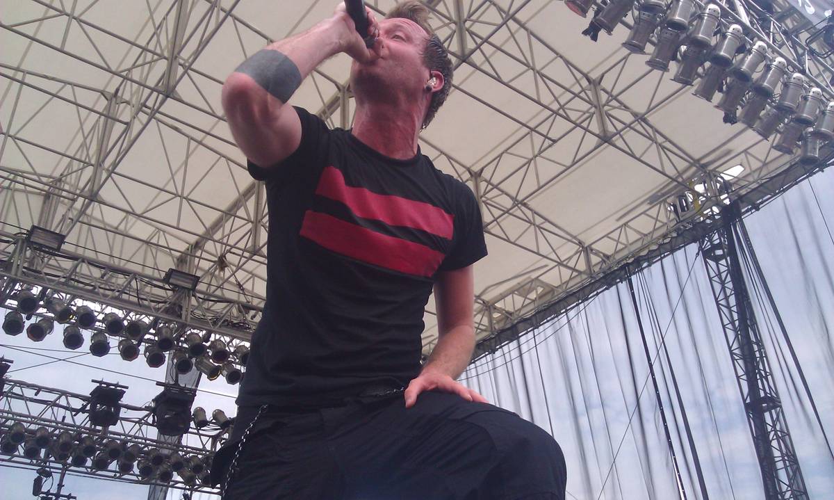 Thousand Foot Krutch singer Trevor McNevan shouting into a microphone