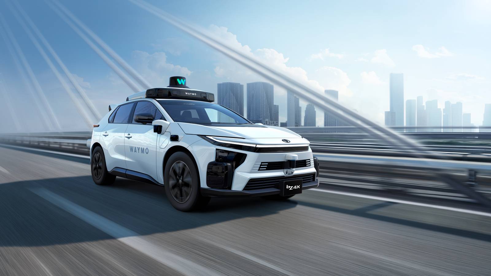 Official Toyota image of a white bZ4X fitted with Waymo self driving sensors, set against a city skyline