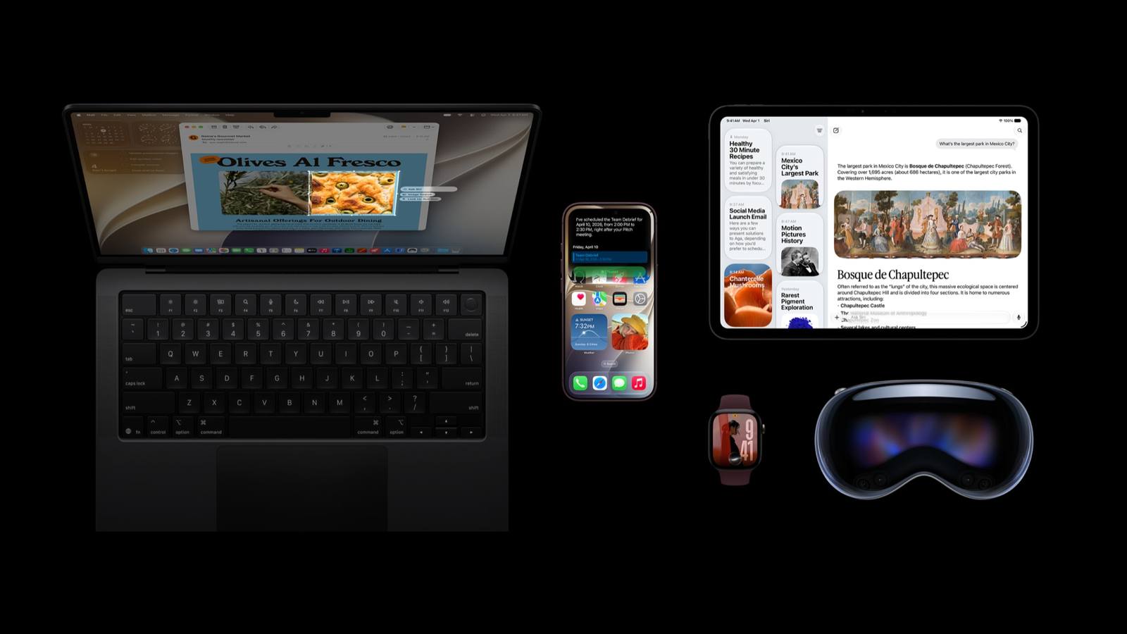 A MacBook, iPad, Vision Pro headset and Apple Watch on black, with a small iPhone between the laptop and iPad
