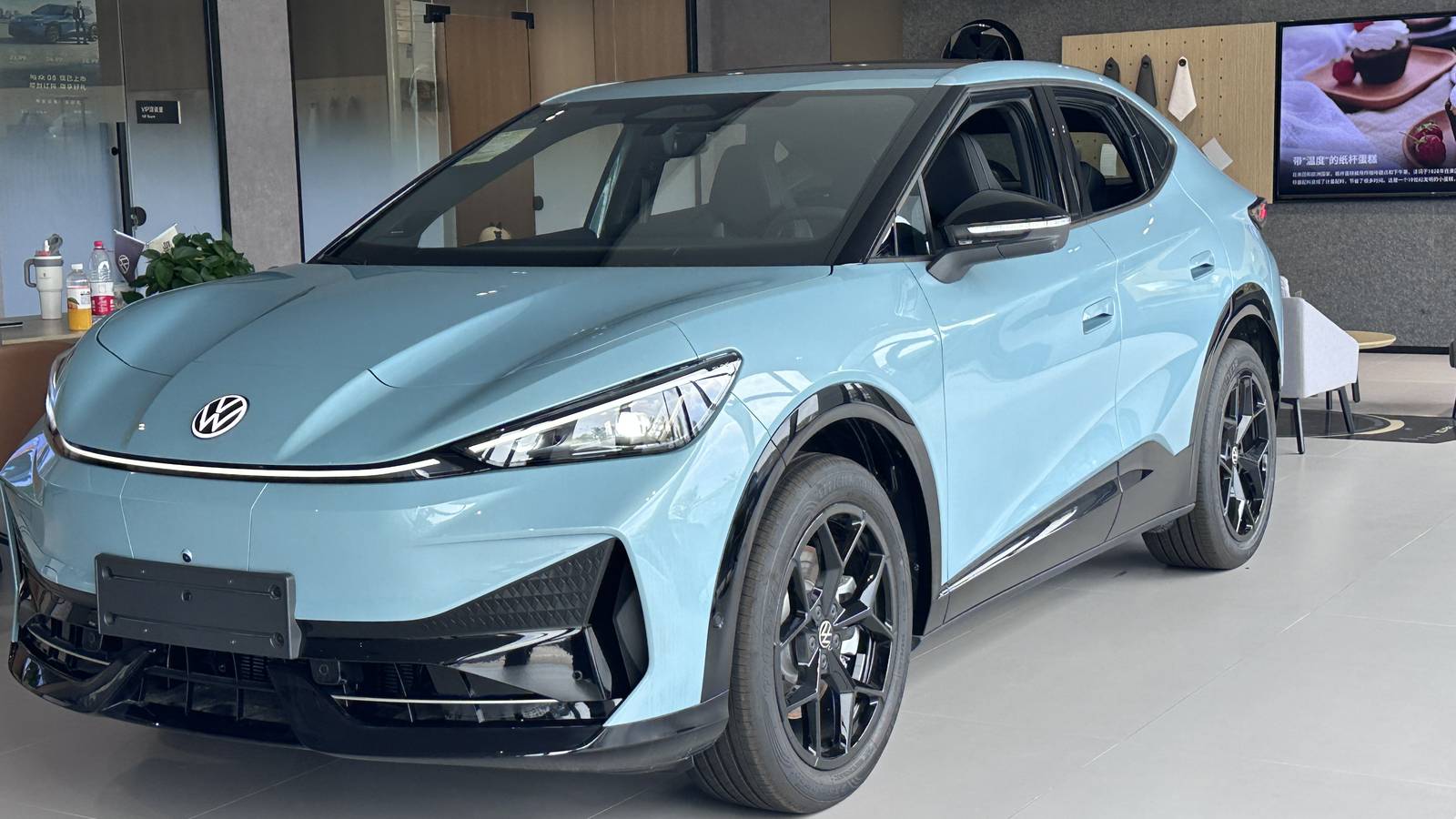 A light blue Volkswagen ID. UNYX 06 electric SUV in a showroom in China