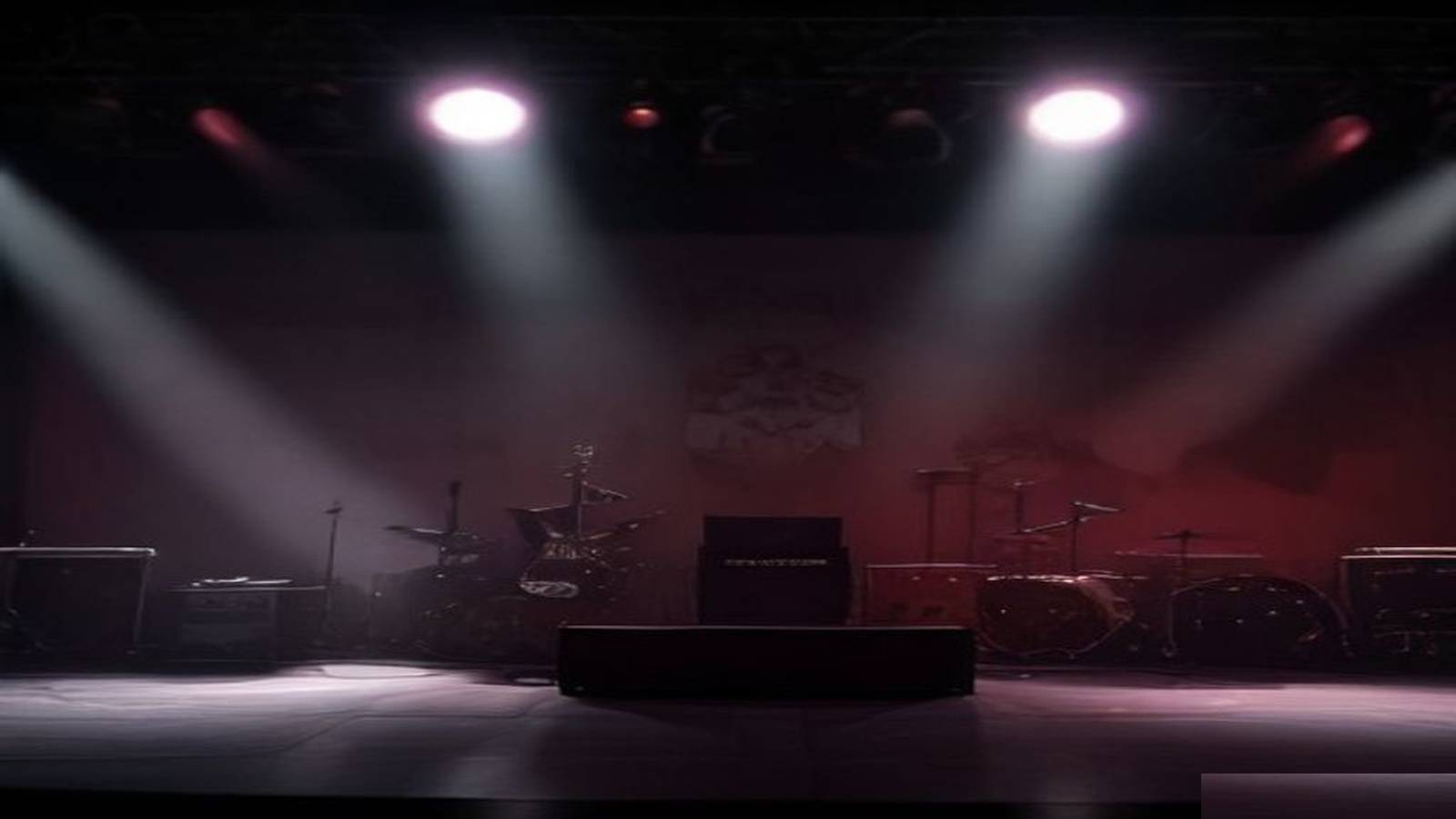 Empty mid-2000s hard-rock stage under red wash — Flyleaf still