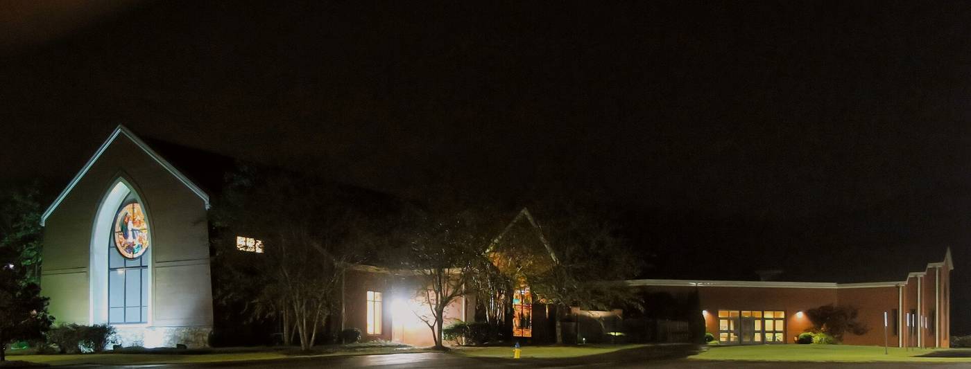 Church exterior at night — Midwestern tour-stop scene still